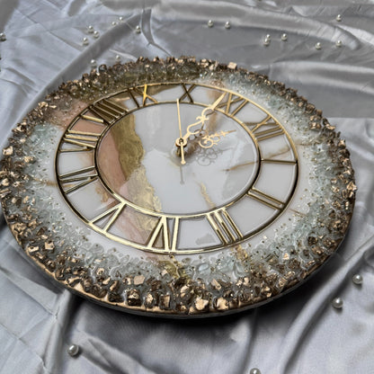 Decorative wall clock with gold Roman numerals on a textured gray background
